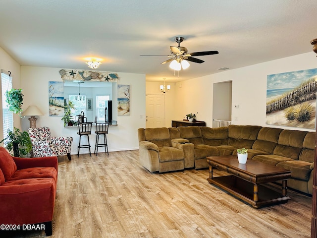 living room featuring light hardwood / wood-style flooring and ceiling fan