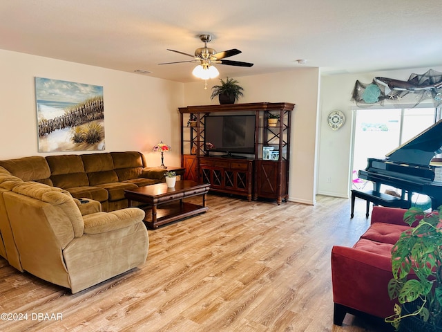 living room featuring ceiling fan and light hardwood / wood-style flooring