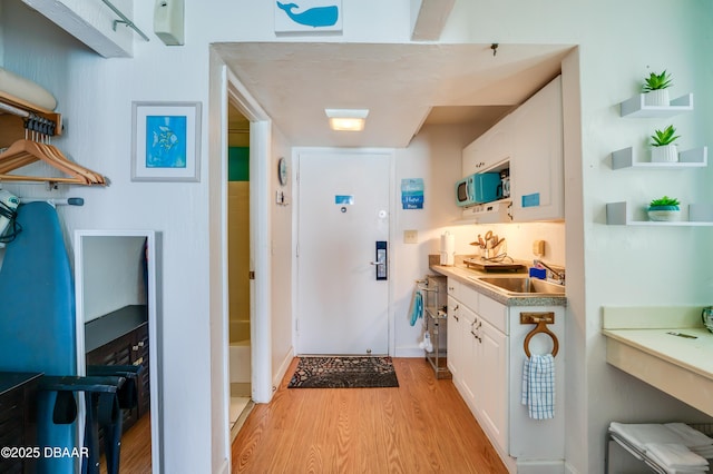 interior space featuring sink and light hardwood / wood-style flooring