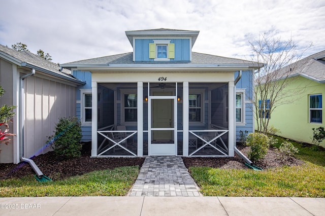 exterior space with roof with shingles