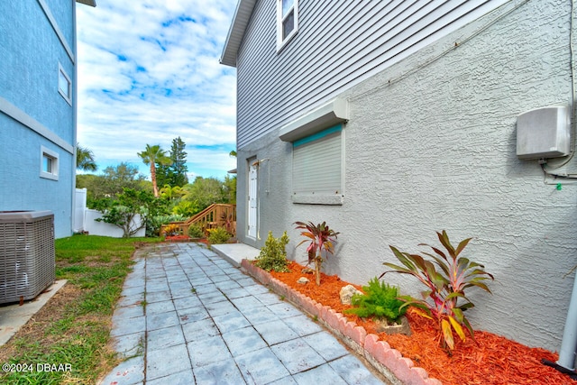 view of home's exterior with central AC and a patio area