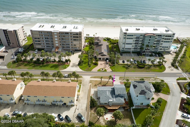 birds eye view of property featuring a water view and a view of the beach