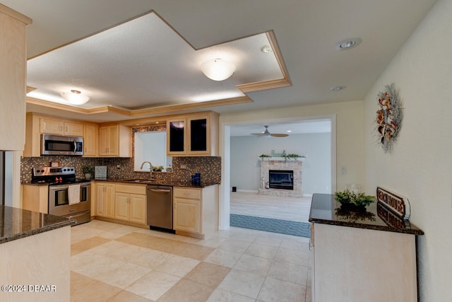 4766 S Atlantic Ave, Ponce Inlet, FL 32127 - kitchen featuring appliances with stainless steel finishes, light brown cabinets, a sink, backsplash, and ceiling fan