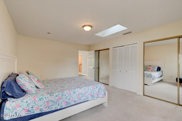 4766 S Atlantic Ave, Ponce Inlet, FL 32127 - bedroom with two closets, a skylight, and carpet