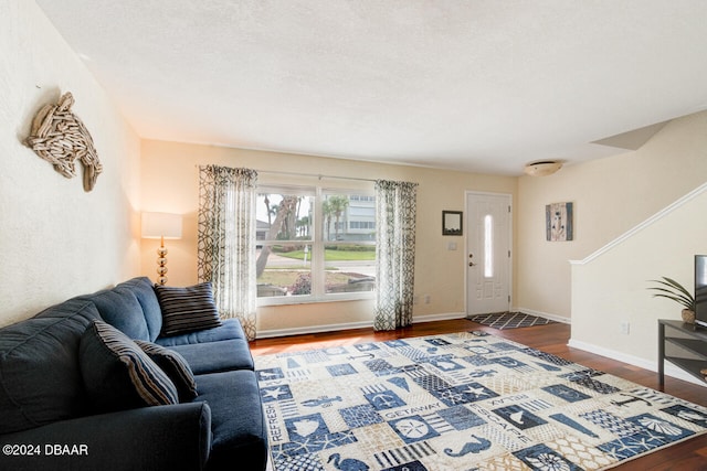 living room with hardwood / wood-style flooring and a textured ceiling