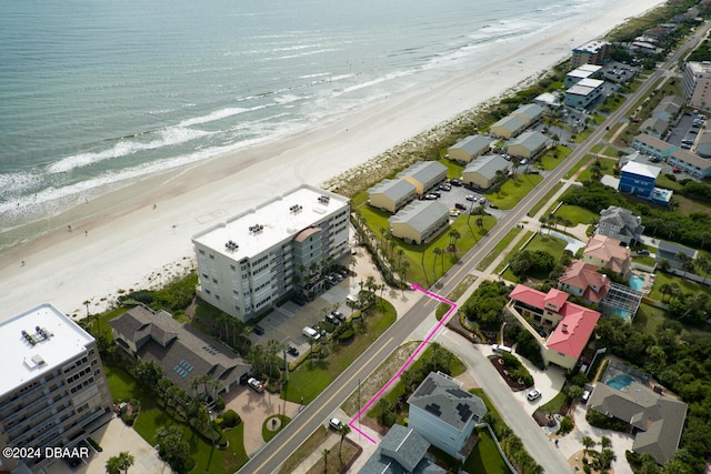 birds eye view of property with a view of the beach and a water view