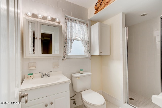 bathroom with an enclosed shower, vanity, toilet, and tile walls