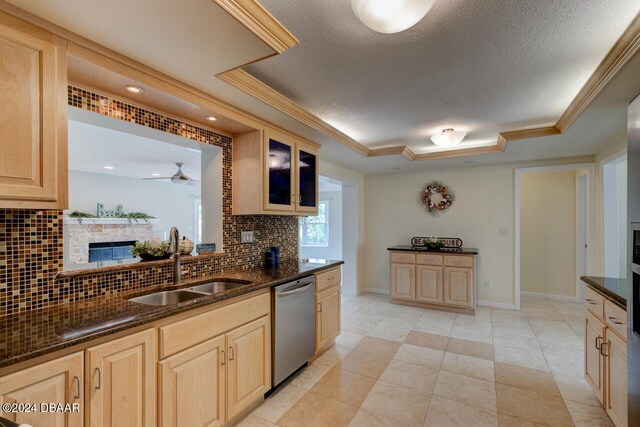 4766 S Atlantic Ave, Ponce Inlet, FL 32127 - kitchen featuring dishwasher, a sink, light brown cabinetry, a tray ceiling, and decorative backsplash