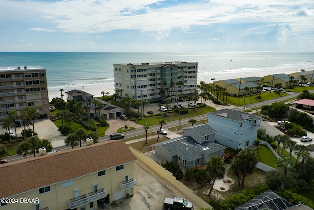 birds eye view of property featuring a beach view and a water view