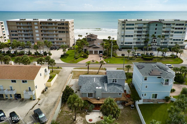 drone / aerial view featuring a beach view and a water view