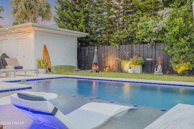 view of pool featuring a yard