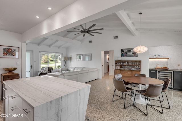 dining space featuring ceiling fan, beverage cooler, and vaulted ceiling with beams