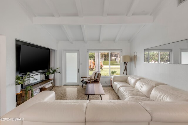 living room featuring vaulted ceiling with beams