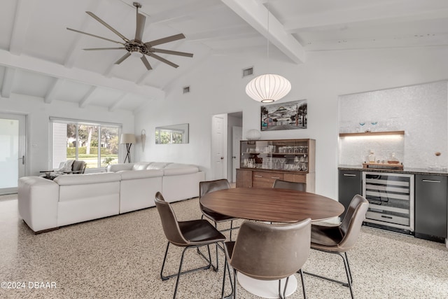 dining area featuring indoor bar, lofted ceiling with beams, ceiling fan, and beverage cooler