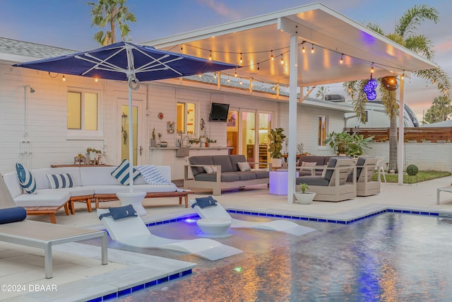 view of pool featuring french doors, an outdoor living space, and a patio area