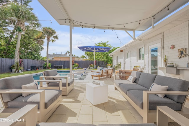 view of patio with an outdoor living space and a fenced in pool