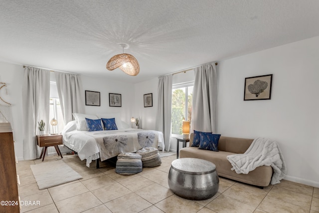 tiled bedroom with a textured ceiling