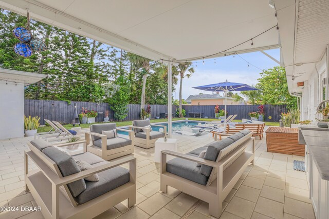 view of patio featuring a fenced in pool and an outdoor living space