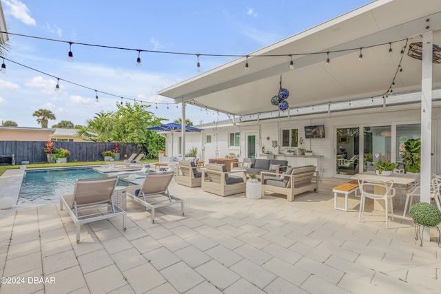 view of patio with an outdoor hangout area and a fenced in pool