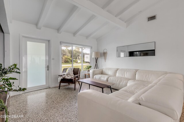 living room featuring vaulted ceiling with beams