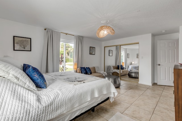 bedroom with light tile patterned floors and a closet