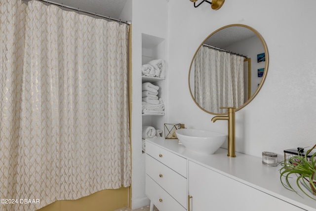 bathroom featuring a shower with curtain, a textured ceiling, and vanity