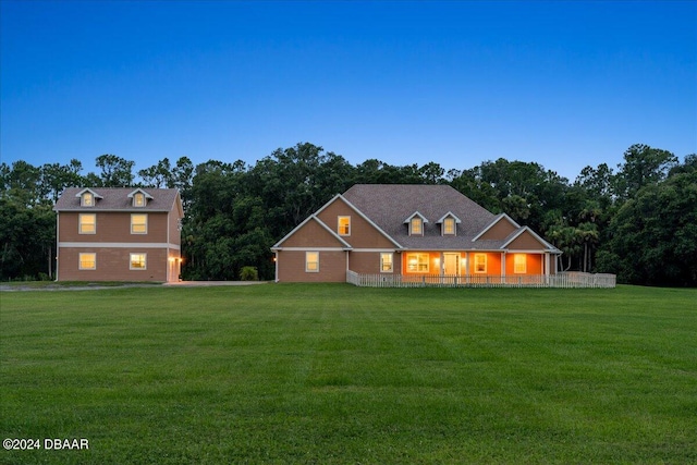 view of front of house featuring covered porch and a lawn