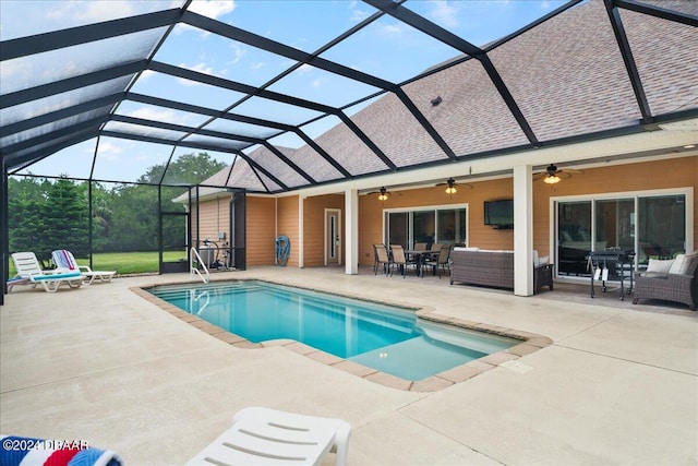 view of swimming pool featuring ceiling fan, a patio, a lanai, and an outdoor living space