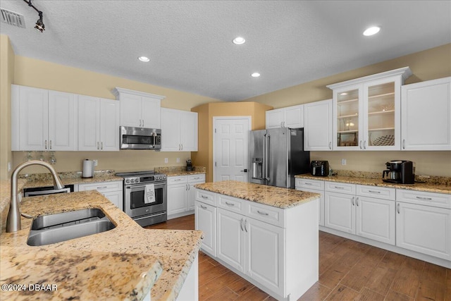 kitchen with white cabinets, sink, and stainless steel appliances