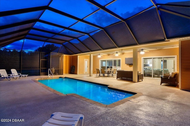 view of swimming pool featuring glass enclosure, a patio area, an outdoor hangout area, and ceiling fan