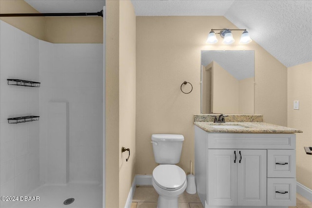 bathroom with tile patterned floors, vanity, a textured ceiling, toilet, and lofted ceiling