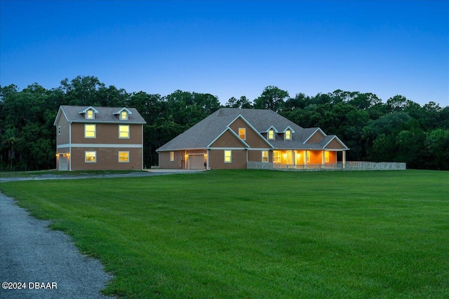 view of front facade featuring a garage and a yard