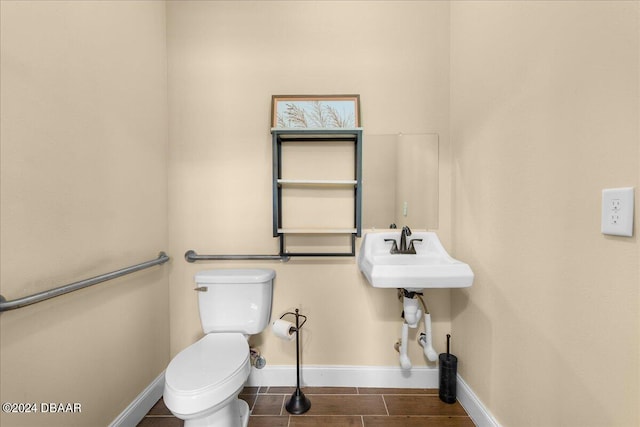 bathroom with tile patterned flooring, toilet, and sink