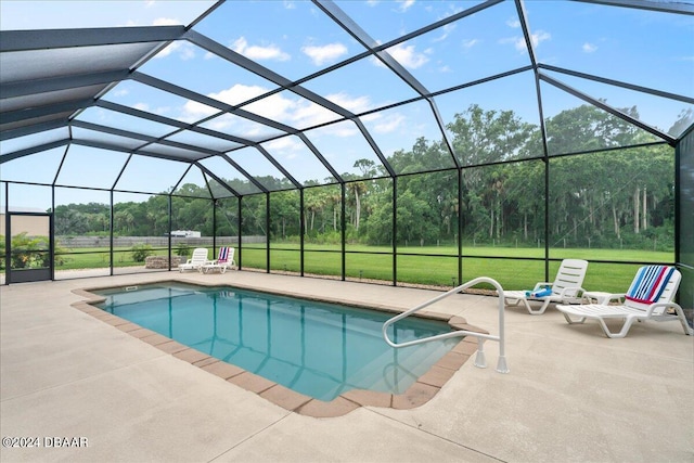 view of pool featuring a lawn, a lanai, and a patio