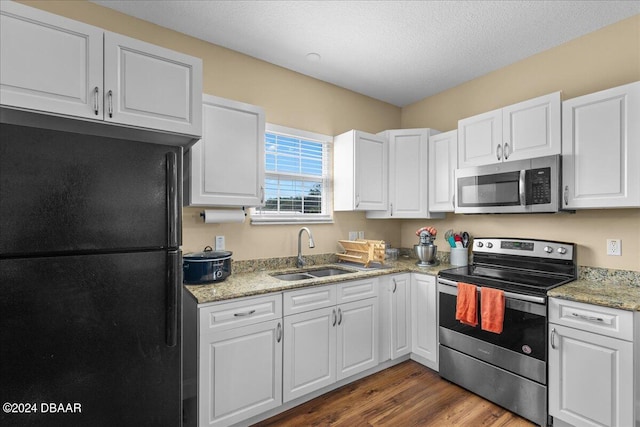 kitchen featuring stainless steel appliances, white cabinets, sink, and dark hardwood / wood-style flooring