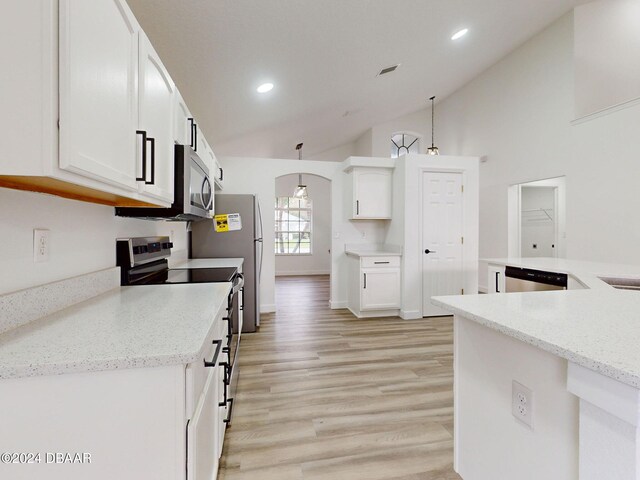 5336 Georgia Peach Ave, Port Orange, FL 32128 - kitchen with stainless steel appliances, vaulted ceiling, white cabinetry, recessed lighting, and arched walkways