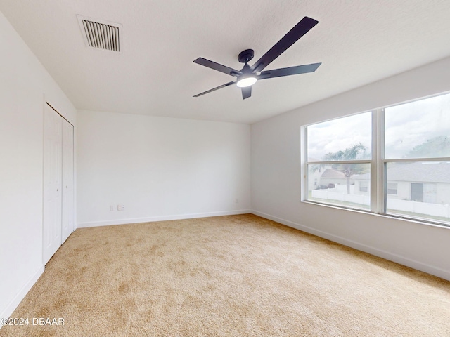5336 Georgia Peach Ave, Port Orange, FL 32128 - unfurnished bedroom featuring carpet, baseboards, a ceiling fan, and a closet