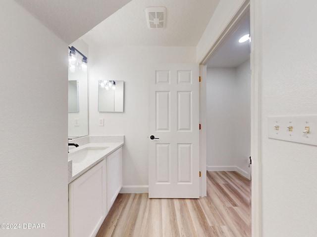 5336 Georgia Peach Ave, Port Orange, FL 32128 - bathroom featuring wood finished floors, vanity, and baseboards