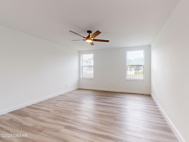 5336 Georgia Peach Ave, Port Orange, FL 32128 - empty room with healthy amount of natural light, a ceiling fan, and light wood-style flooring