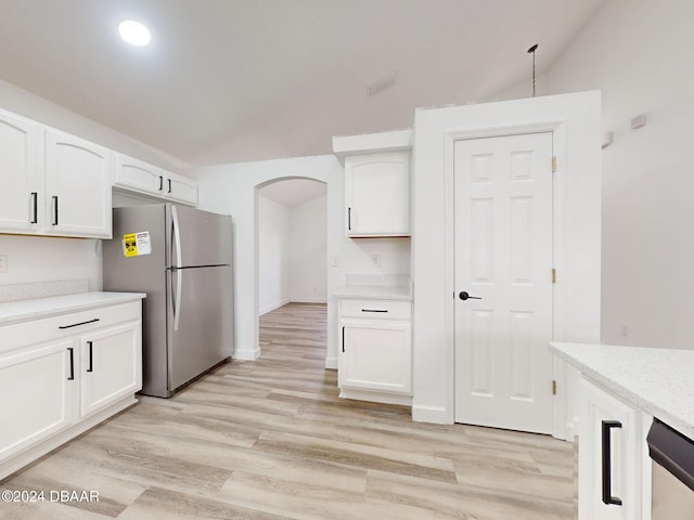 5336 Georgia Peach Ave, Port Orange, FL 32128 - kitchen featuring appliances with stainless steel finishes, lofted ceiling, light wood finished floors, white cabinetry, and arched walkways