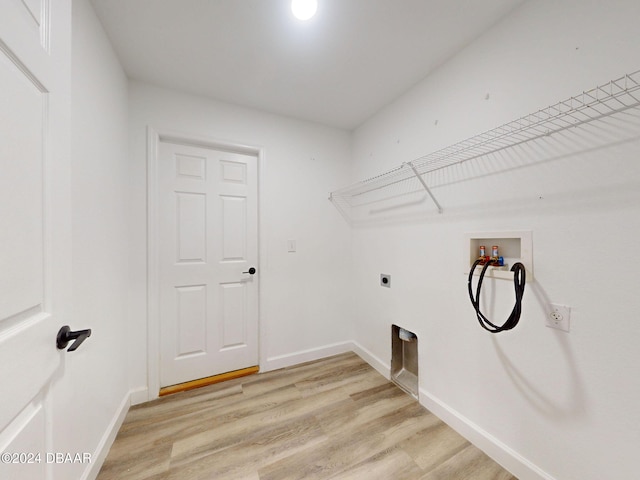 5336 Georgia Peach Ave, Port Orange, FL 32128 - washroom featuring hookup for an electric dryer, hookup for a washing machine, light wood-style flooring, and baseboards