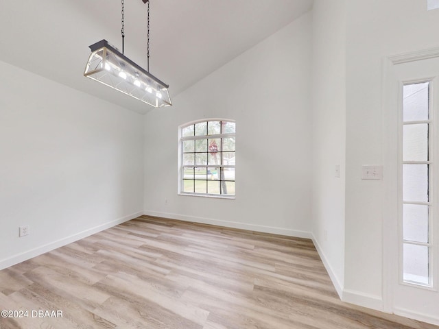 5336 Georgia Peach Ave, Port Orange, FL 32128 - unfurnished room featuring high vaulted ceiling, light wood finished floors, and baseboards