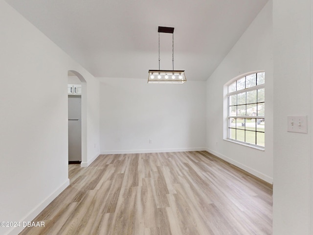 5336 Georgia Peach Ave, Port Orange, FL 32128 - empty room with light wood-style flooring, arched walkways, lofted ceiling, and baseboards