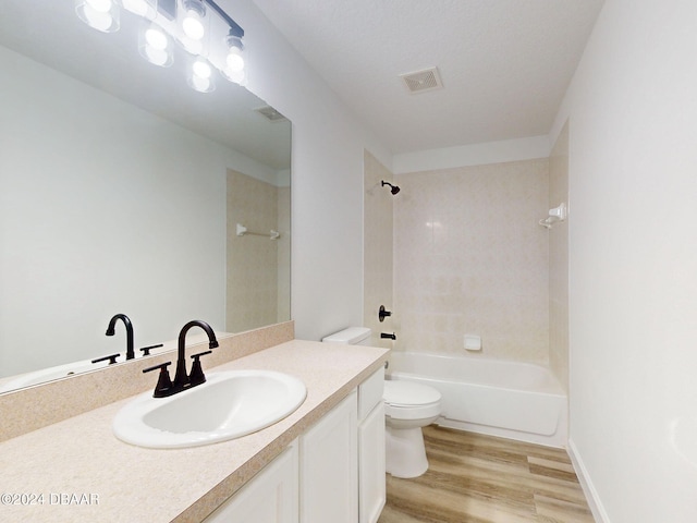 5336 Georgia Peach Ave, Port Orange, FL 32128 - bathroom with toilet, wood finished floors, vanity, and shower / bathtub combination