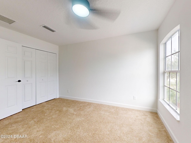 5336 Georgia Peach Ave, Port Orange, FL 32128 - unfurnished bedroom with carpet flooring, multiple windows, and baseboards