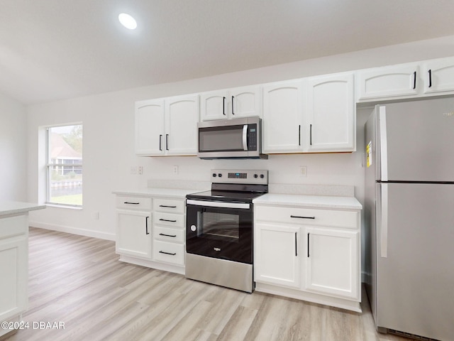5336 Georgia Peach Ave, Port Orange, FL 32128 - kitchen with stainless steel appliances, white cabinets, light wood-type flooring, light countertops, and recessed lighting
