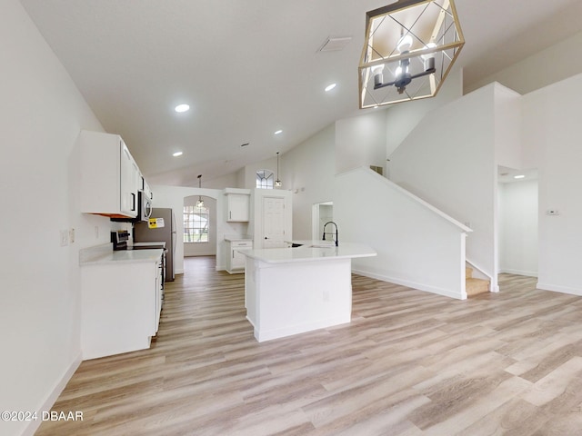 5336 Georgia Peach Ave, Port Orange, FL 32128 - kitchen featuring a sink, light wood-style floors, recessed lighting, an island with sink, and white cabinets