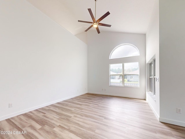 5336 Georgia Peach Ave, Port Orange, FL 32128 - spare room featuring high vaulted ceiling, light wood-type flooring, ceiling fan, and baseboards