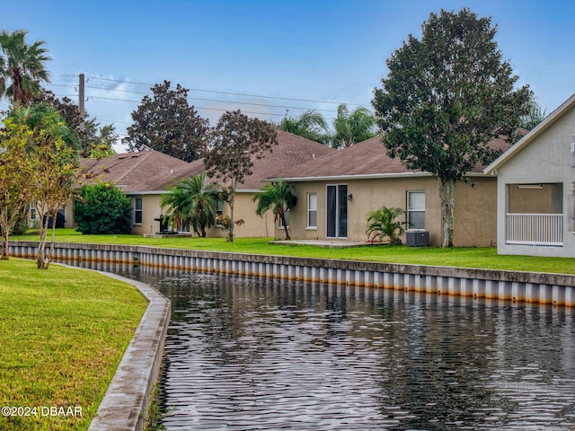 5336 Georgia Peach Ave, Port Orange, FL 32128 - back of property with stucco siding, central AC, a water view, and a yard