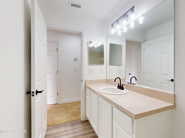 5336 Georgia Peach Ave, Port Orange, FL 32128 - bathroom featuring wood finished floors, vanity, and baseboards